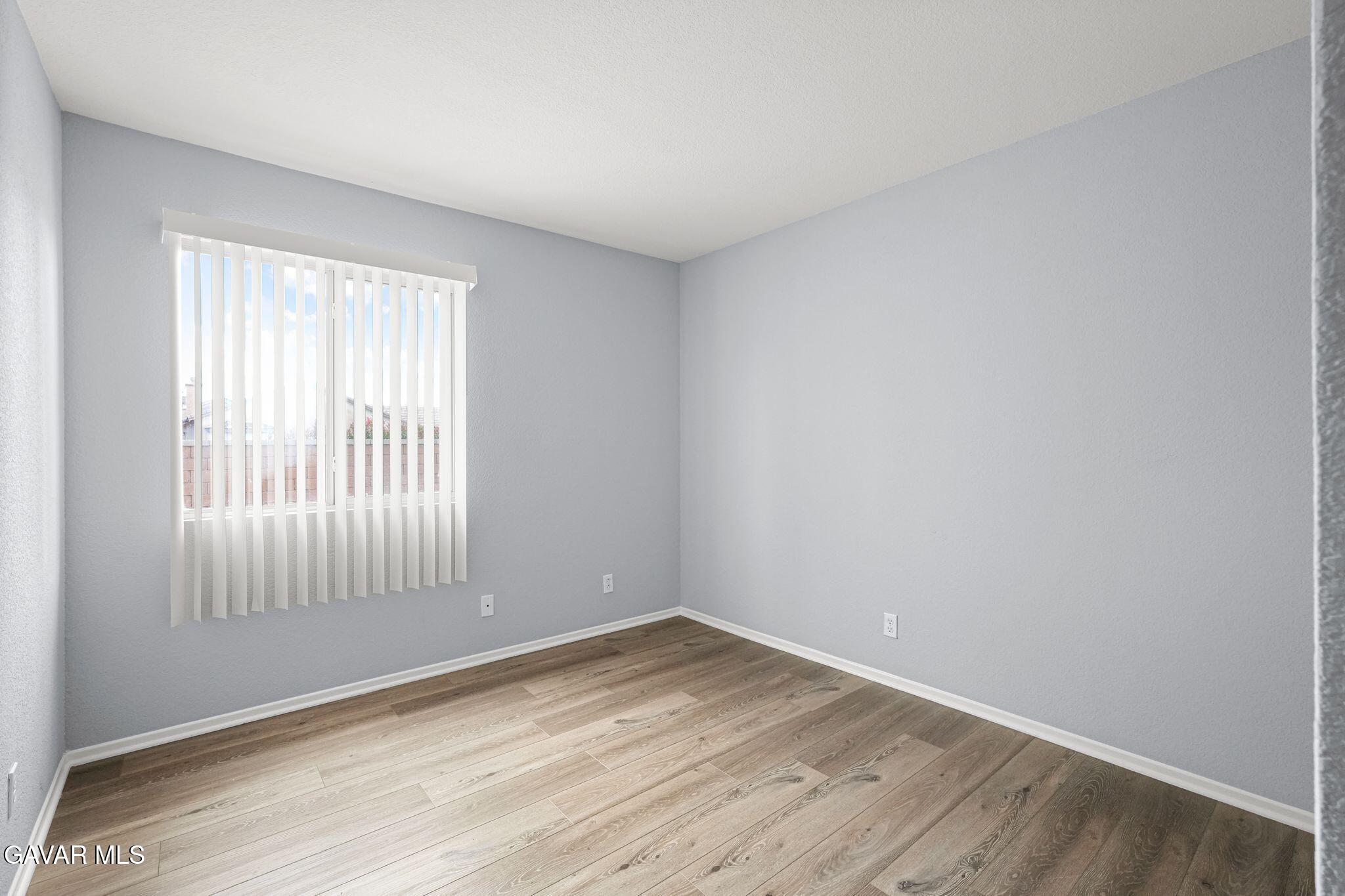2108 Manchester Street Rosamond, CA 93560 - Photo 26 of 41 an empty room with wooden floor and windows