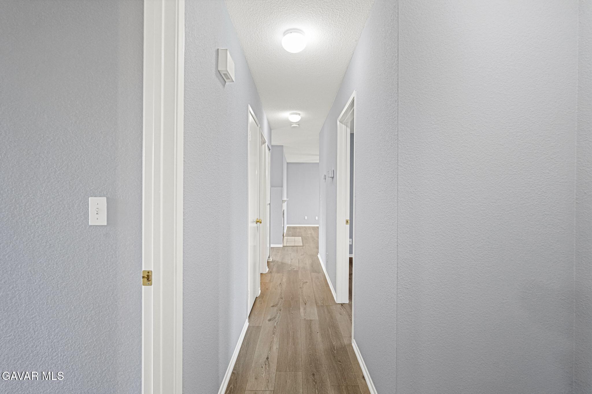 2108 Manchester Street Rosamond, CA 93560 - Photo 27 of 41 a view of a hallway with wooden floor
