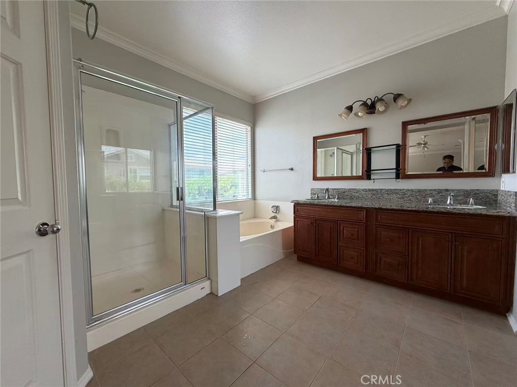 7162 Breno Place Rancho Cucamonga, CA 91701 - Photo 12 of 20 a spacious bathroom with a granite countertop sink mirror and bathtub
