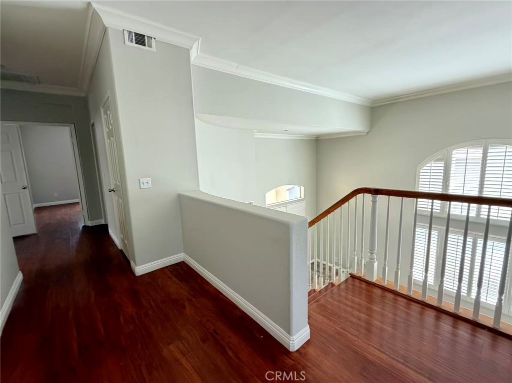 7162 Breno Place Rancho Cucamonga, CA 91701 - Photo 13 of 20 a view of a hallway with wooden floor and stairs