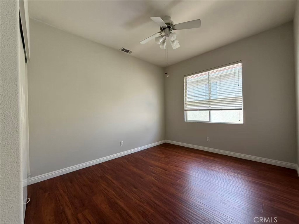 7162 Breno Place Rancho Cucamonga, CA 91701 - Photo 16 of 20 a view of an empty room with wooden floor and a window
