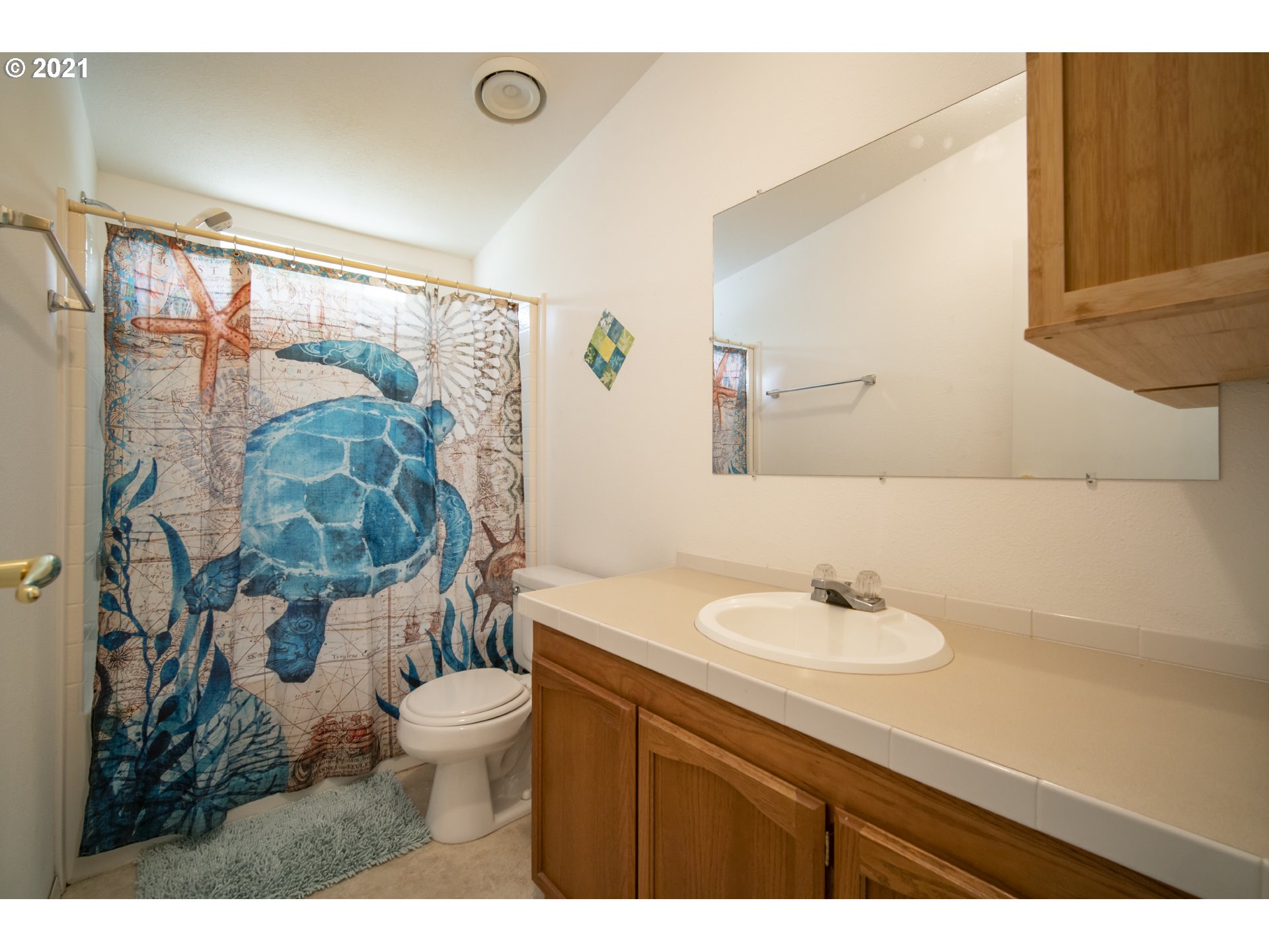 887 Jackson Avenue Southwest Bandon, OR 97411 - Photo 16 of 20 a bathroom with a sink and a mirror