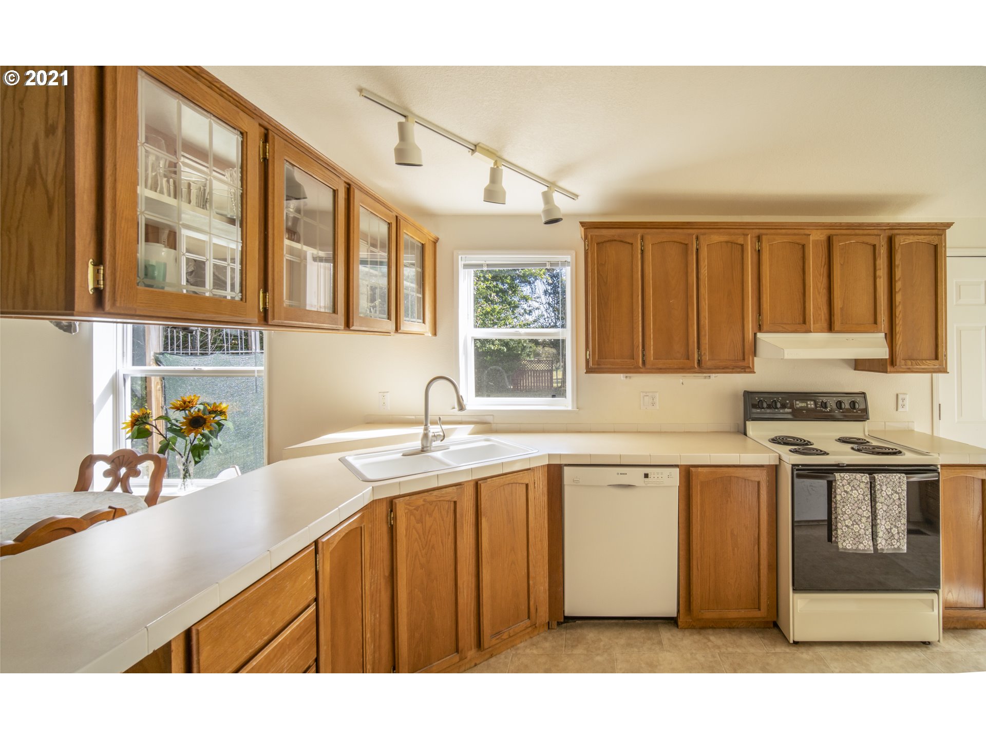 887 Jackson Avenue Southwest Bandon, OR 97411 - Photo 9 of 20 a kitchen with stainless steel appliances granite countertop a sink stove and cabinets
