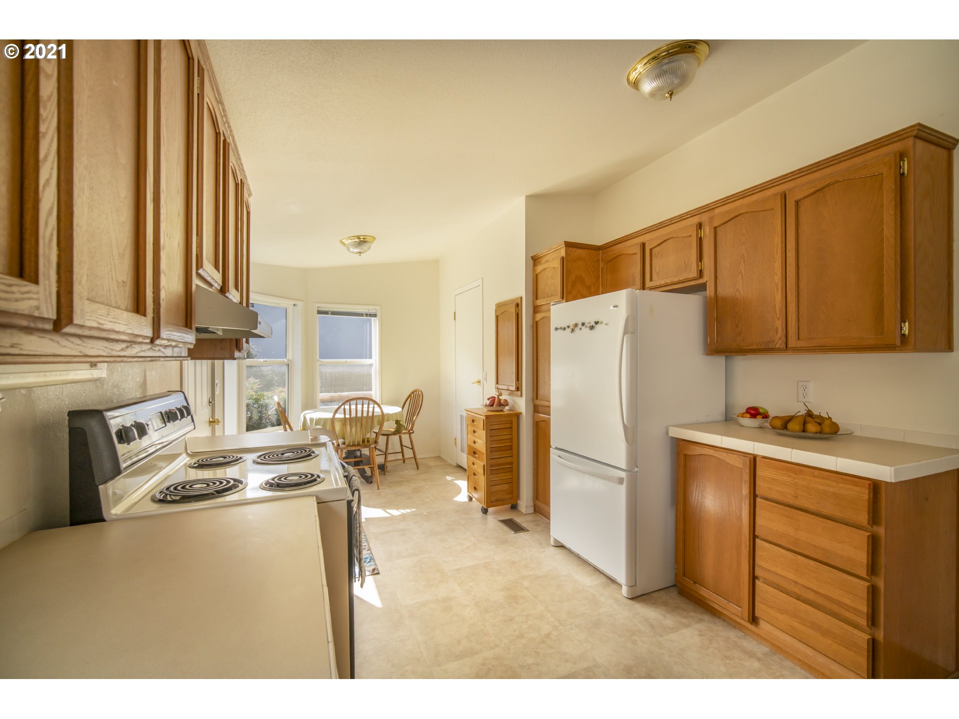887 Jackson Avenue Southwest Bandon, OR 97411 - Photo 10 of 20 a kitchen with stainless steel appliances granite countertop a refrigerator a stove and a sink with cabinets