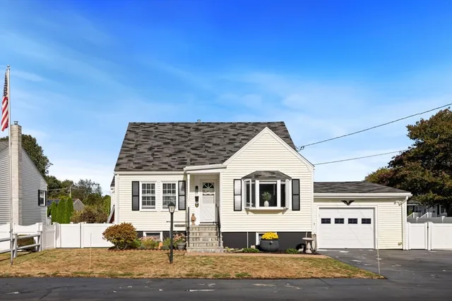 a view of a white house with a yard