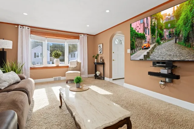 a living room with furniture large window and flat screen tv