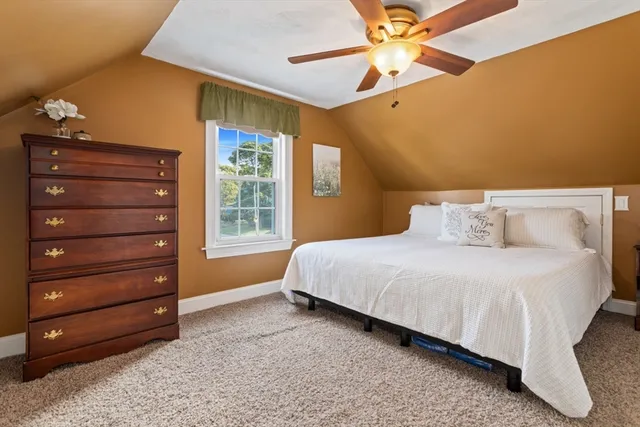 a bedroom with a bed and a ceiling fan