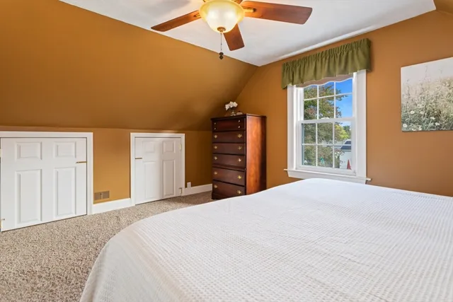 a bedroom with a bed and a dresser