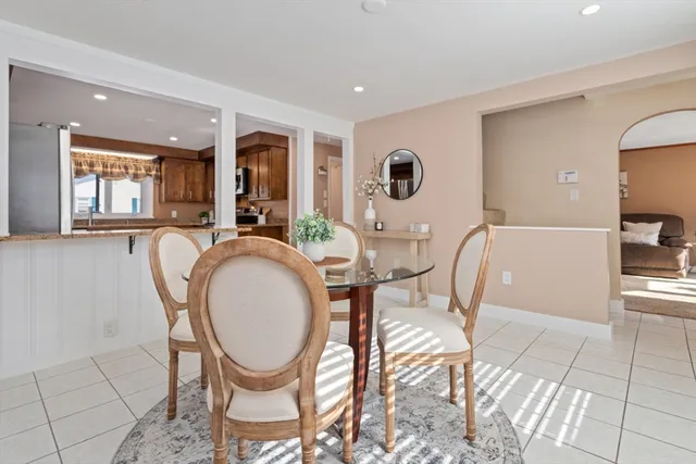 a living room with furniture a flat screen tv and a large window
