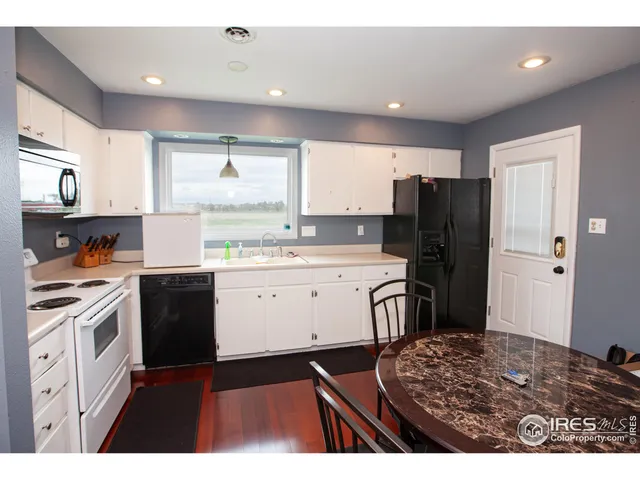 a kitchen with a refrigerator stove and sink