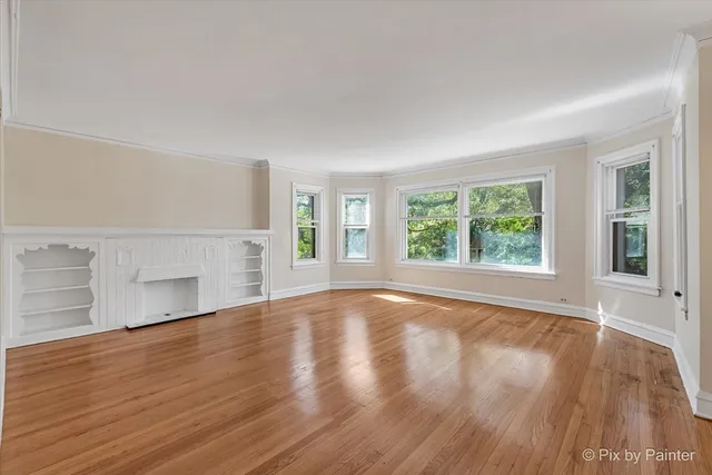 a kitchen with cabinets wooden floor and stainless steel appliances