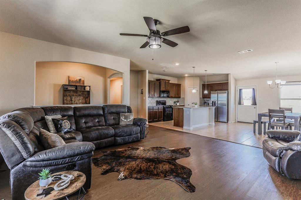 120 Hillcrest Lane Decatur, TX 76234 - Photo 15 of 33 a living room with furniture kitchen view and a wooden floor