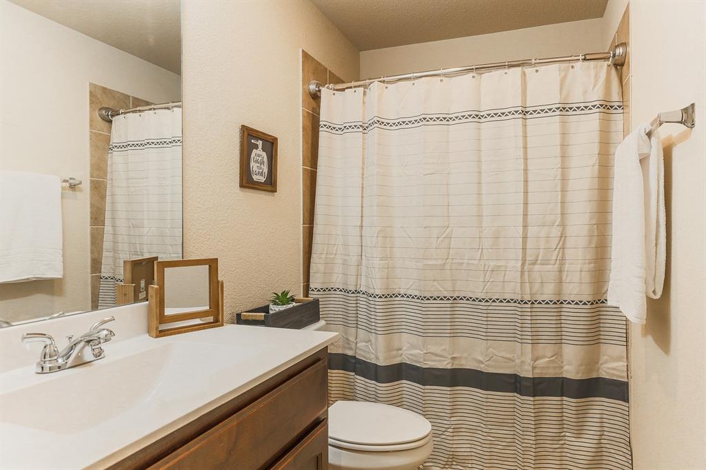 120 Hillcrest Lane Decatur, TX 76234 - Photo 16 of 33 a bathroom with a sink a toilet and shower