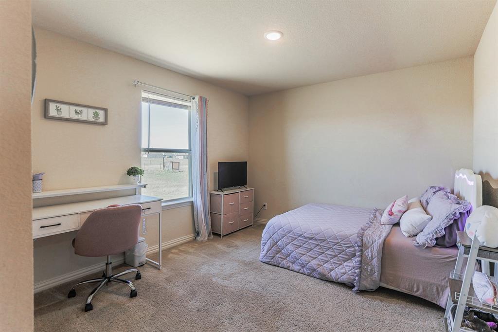 120 Hillcrest Lane Decatur, TX 76234 - Photo 17 of 33 a bedroom with a bed a desk and chair