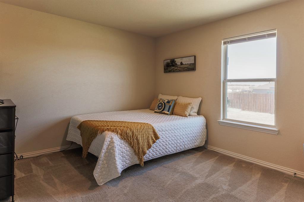 120 Hillcrest Lane Decatur, TX 76234 - Photo 20 of 33 a bed sitting in a bedroom next to a window