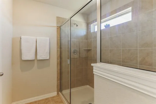a bathroom with a shower and a sink