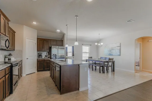 a kitchen with lots of counter top space and appliances