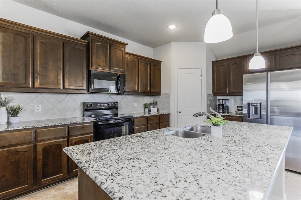 120 Hillcrest Lane Decatur, TX 76234 - Photo 9 of 33 a kitchen with stainless steel appliances granite countertop a sink stove and refrigerator
