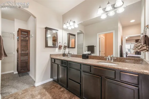 a bathroom with a double vanity sink and a mirror