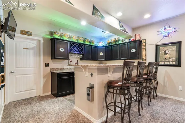 a view of kitchen with stainless steel appliances kitchen island a stove a table and chairs in it