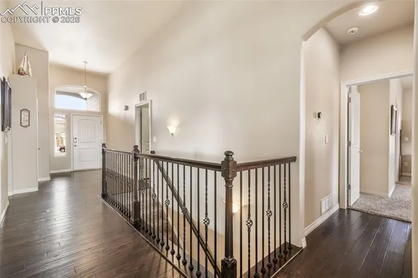a view of a hallway with wooden floor