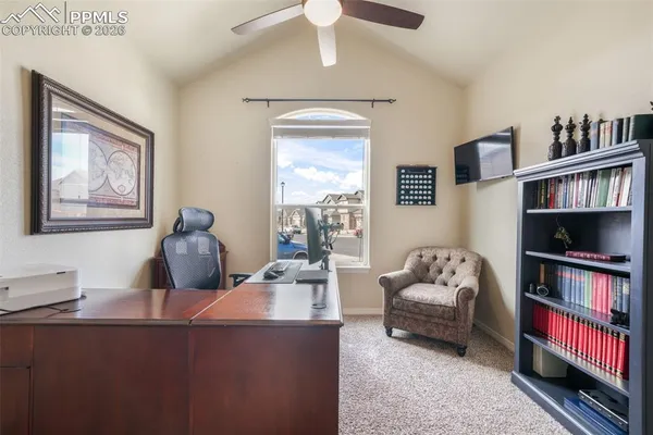 a living room with furniture and book shelf