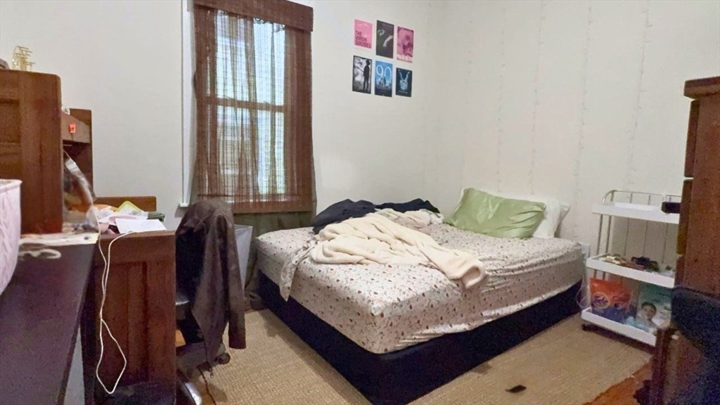 26 Darling Street, Unit 2 Boston, MA 02120 - Photo 11 of 25 a bedroom with a bed and wooden floor