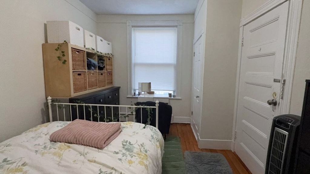 26 Darling Street, Unit 2 Boston, MA 02120 - Photo 8 of 25 a bedroom with a bed and a table in it