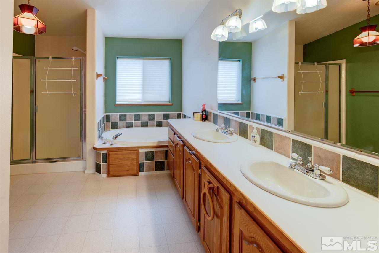 5396 Cody Road Fallon, NV 89406 - Photo 16 of 24 a bathroom with a double vanity sink mirror and bathtub