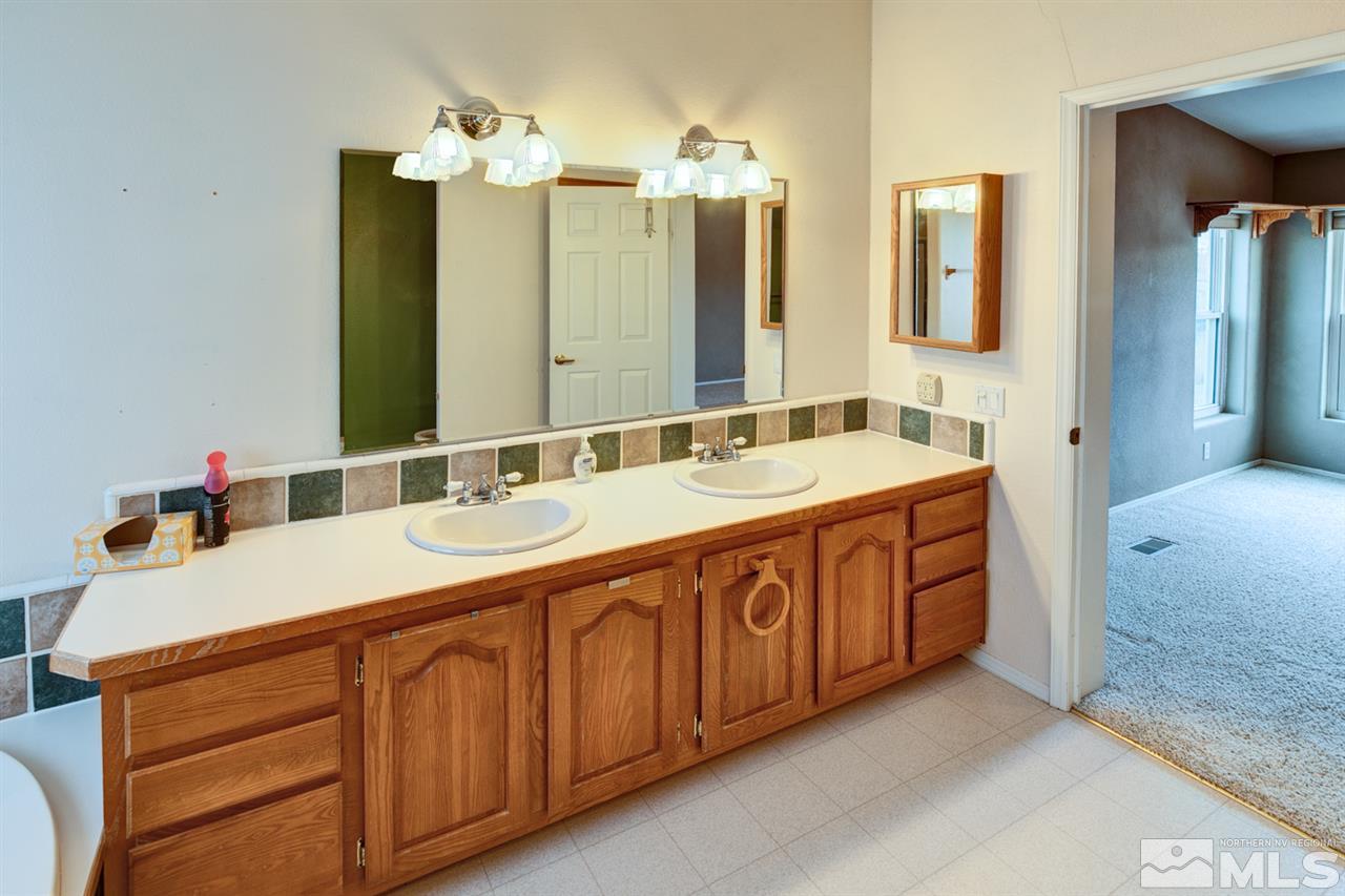 5396 Cody Road Fallon, NV 89406 - Photo 17 of 24 a bathroom with double vanity sinks and a mirror