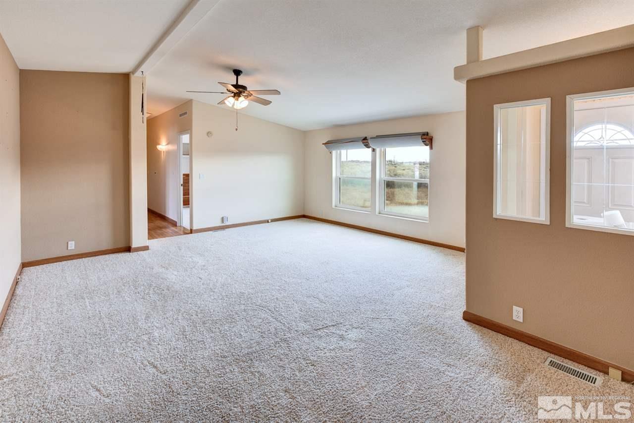 5396 Cody Road Fallon, NV 89406 - Photo 4 of 24 an empty room with chandelier fan and windows