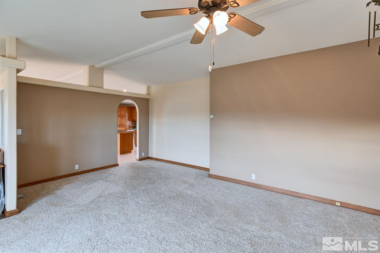 5396 Cody Road Fallon, NV 89406 - Photo 5 of 24 an empty room with a ceiling fan and a window
