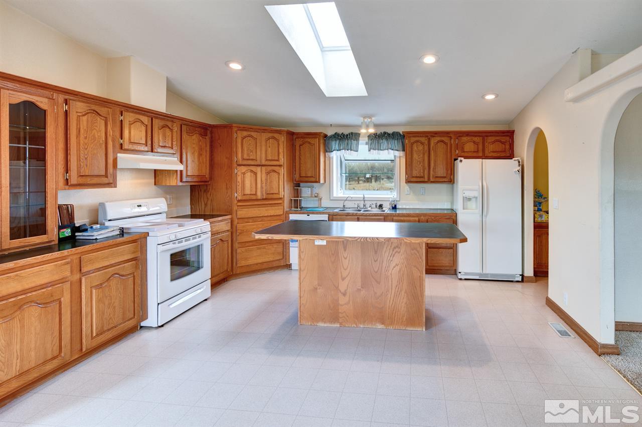 5396 Cody Road Fallon, NV 89406 - Photo 6 of 24 a kitchen with stainless steel appliances granite countertop a stove top oven a refrigerator a sink and dishwasher