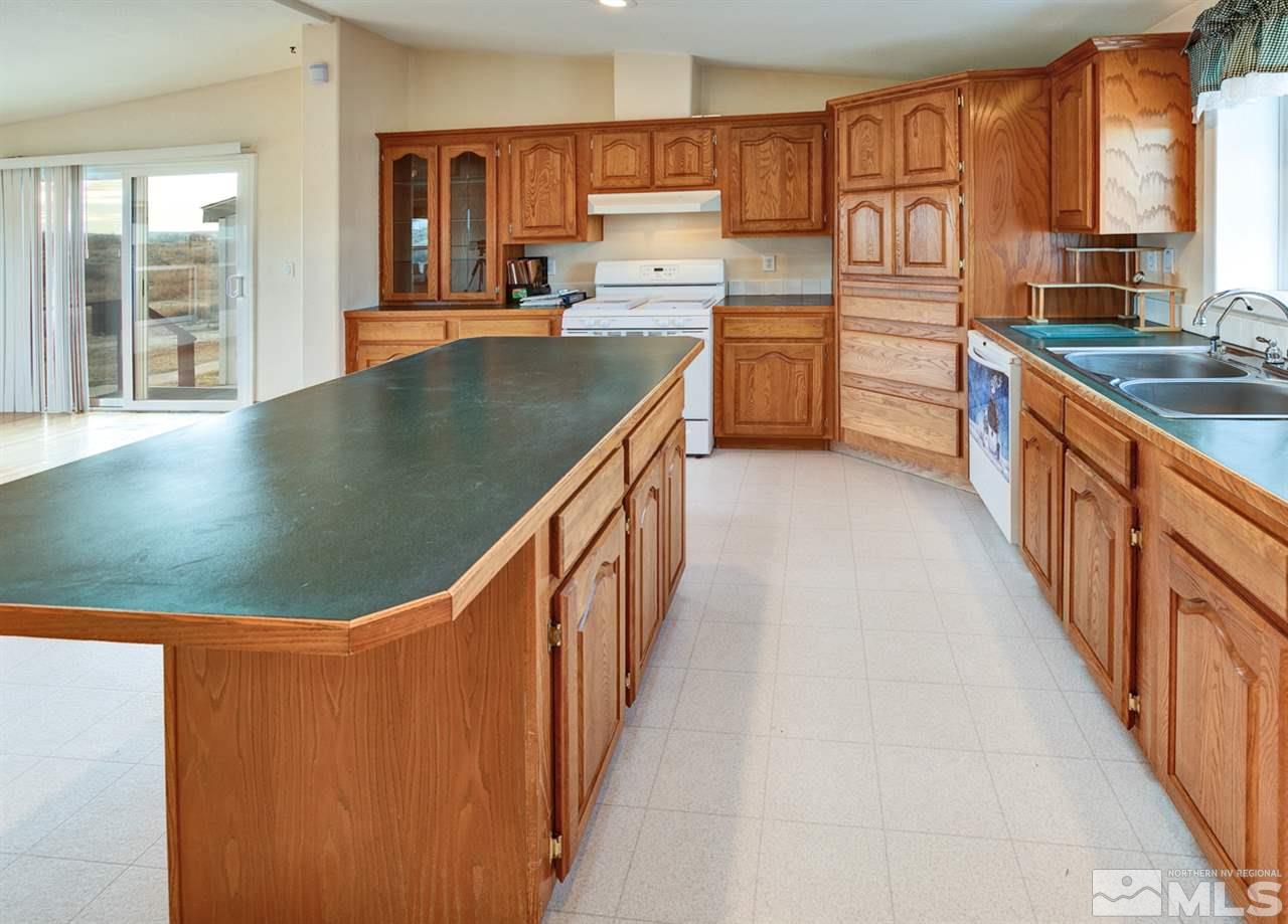 5396 Cody Road Fallon, NV 89406 - Photo 7 of 24 a kitchen with stainless steel appliances granite countertop a sink a stove top oven a counter space and cabinets