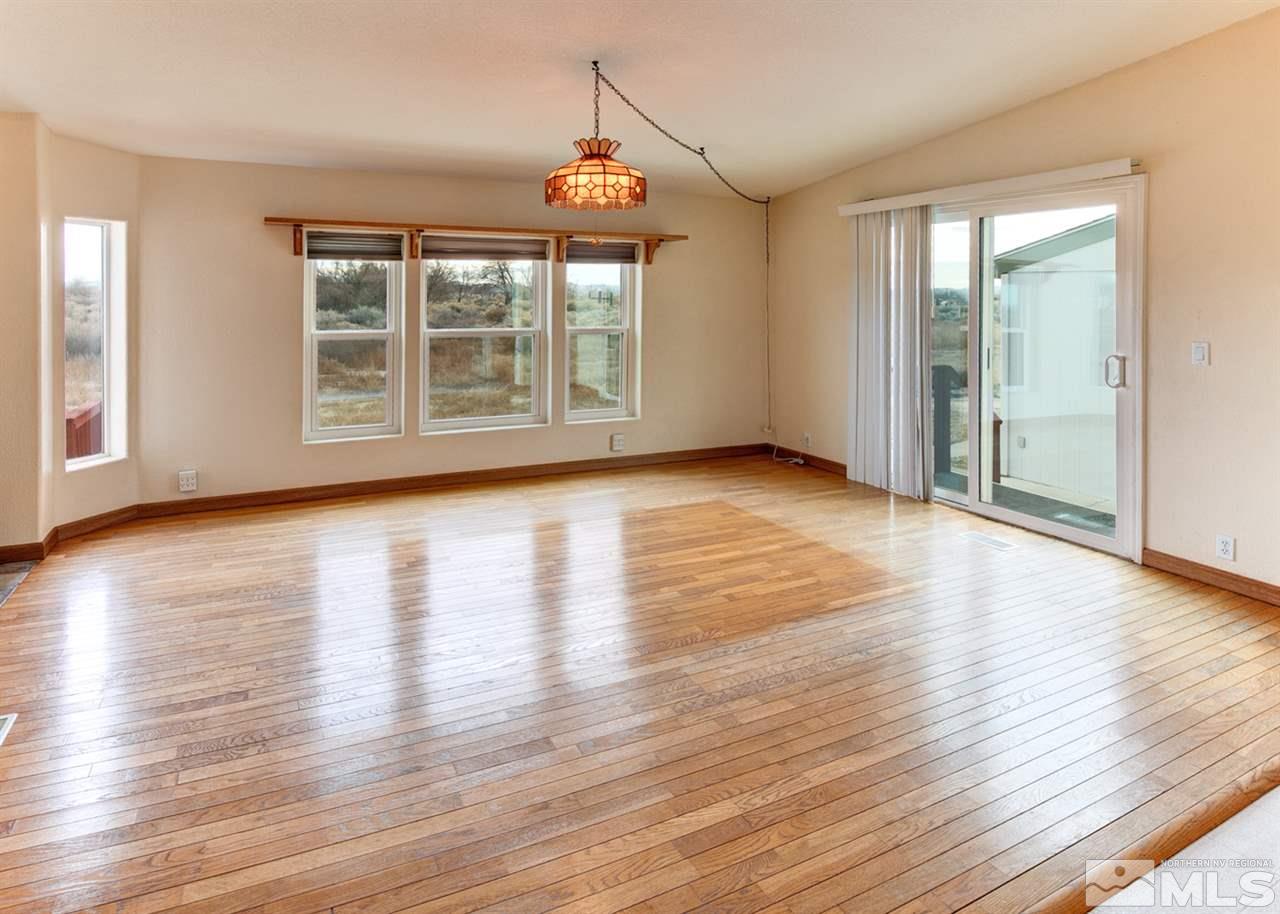 5396 Cody Road Fallon, NV 89406 - Photo 8 of 24 an empty room with wooden floor and windows