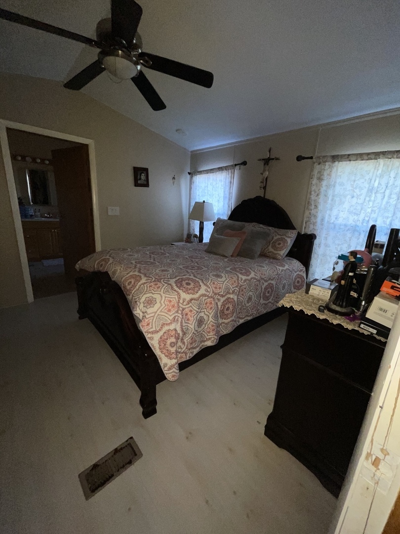 657 Huntsbridge Road Matteson, IL 60443 - Photo 4 of 8 a bedroom with bed mirror and window