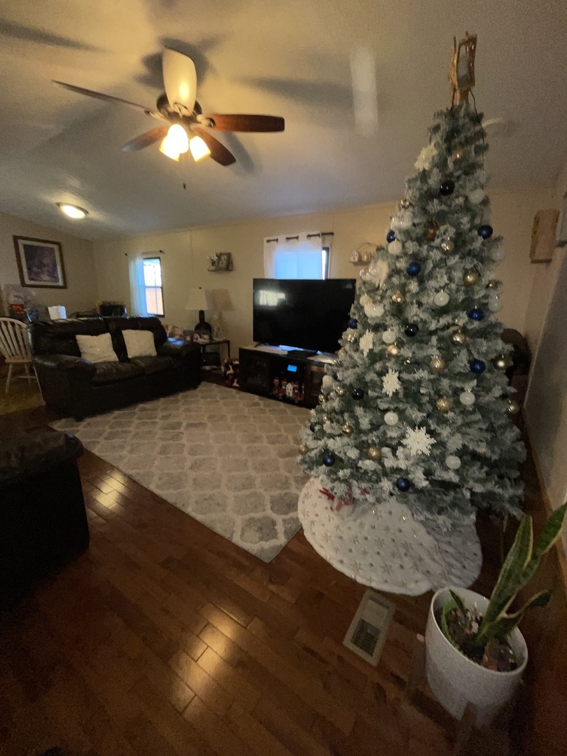 657 Huntsbridge Road Matteson, IL 60443 - Photo 5 of 8 a living room with furniture a flat screen tv and a fireplace