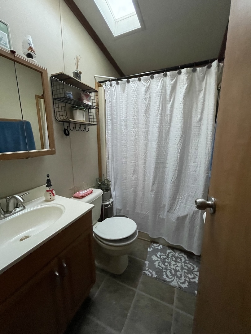 657 Huntsbridge Road Matteson, IL 60443 - Photo 8 of 8 a bathroom with a sink and a mirror
