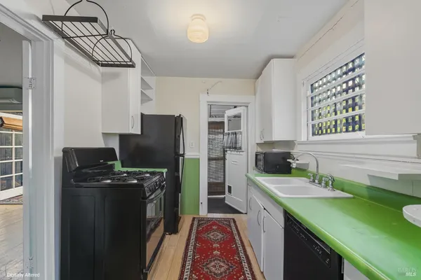 a kitchen with a sink stove and refrigerator