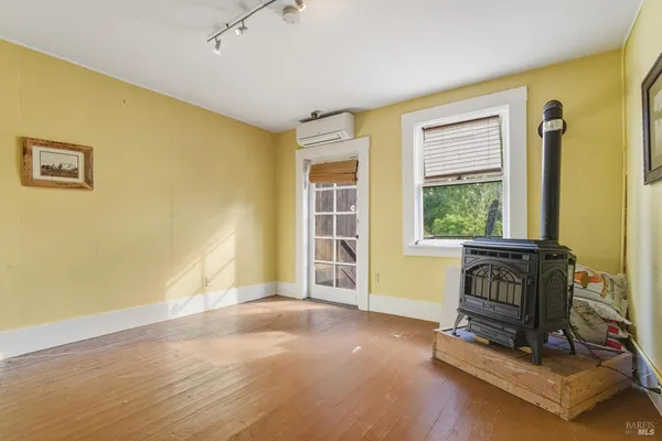 a living room with a bed furniture and a window