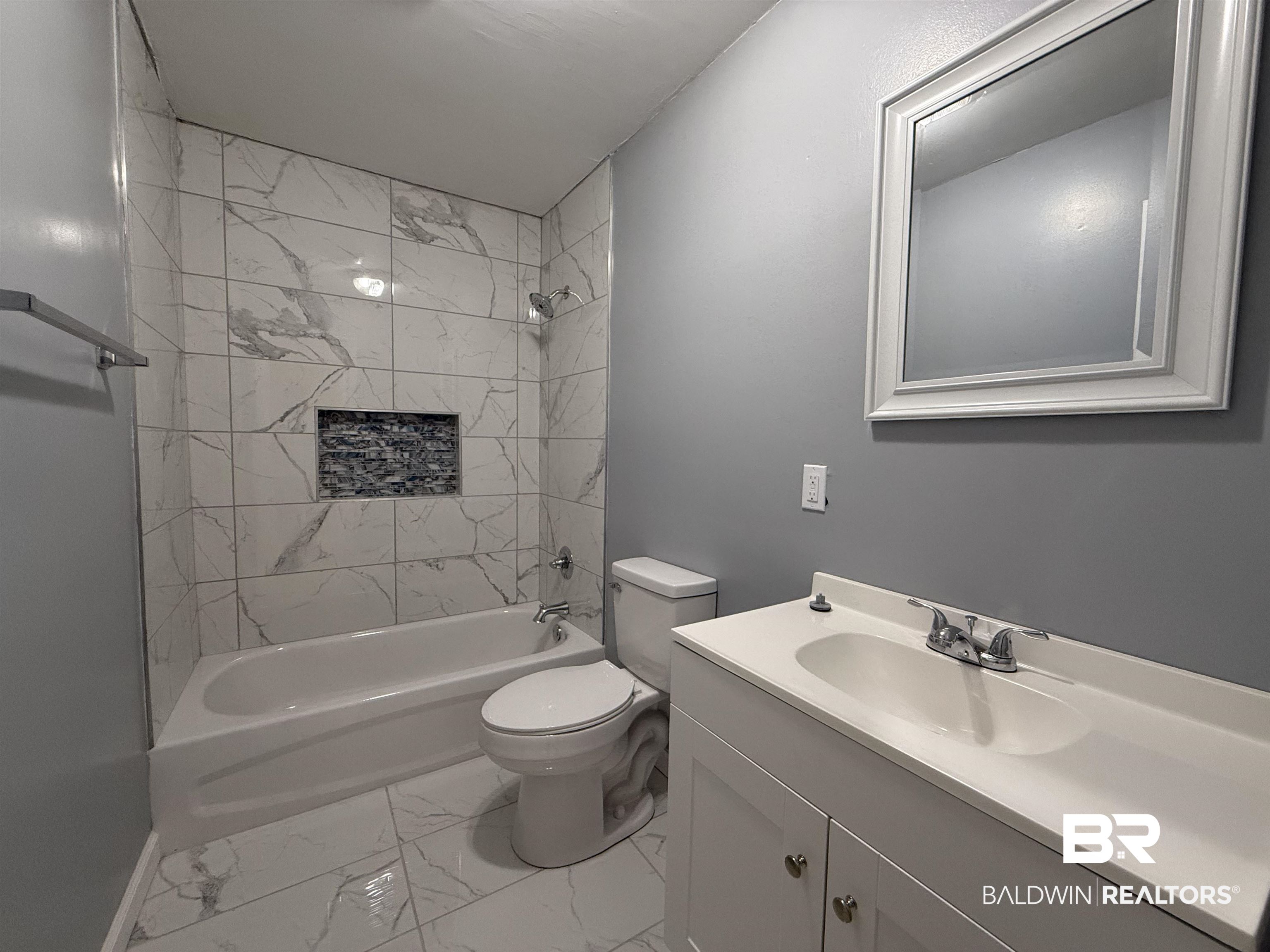 320 E Street Prichard, AL 36610 - Photo 7 of 16 Full bathroom featuring tiled shower / bath, vanity, and toilet