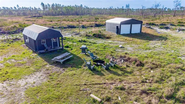 a aerial view of a house with a yard and lake view