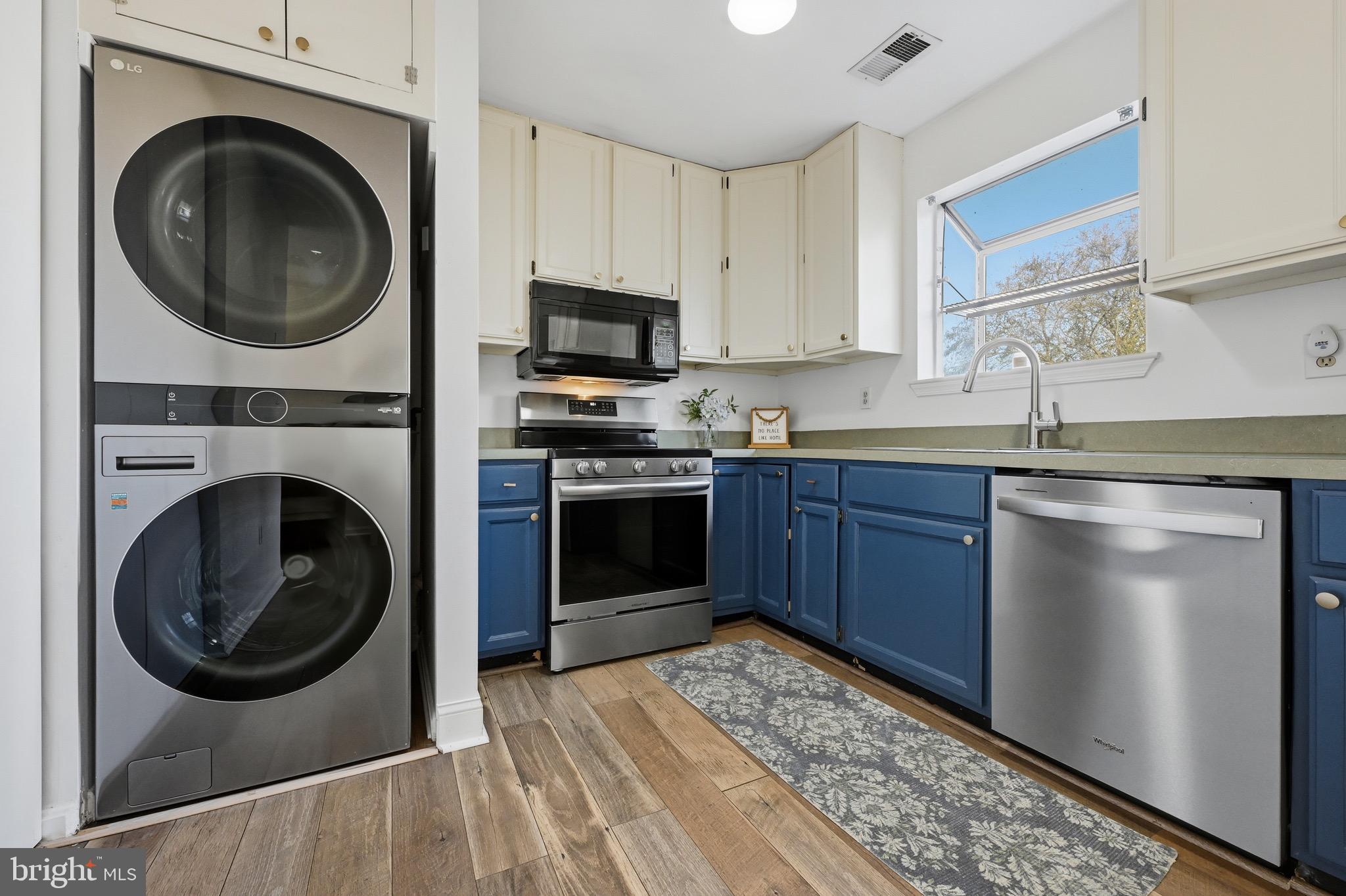 1707 Millstone Drive Edgewater, MD 21037 - Photo 11 of 39 a kitchen with stainless steel appliances granite countertop a sink a stove a washer and dryer