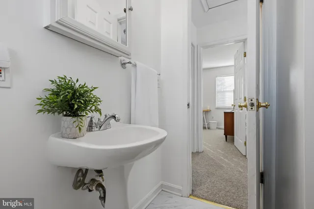 a bathroom with a sink a mirror and shower