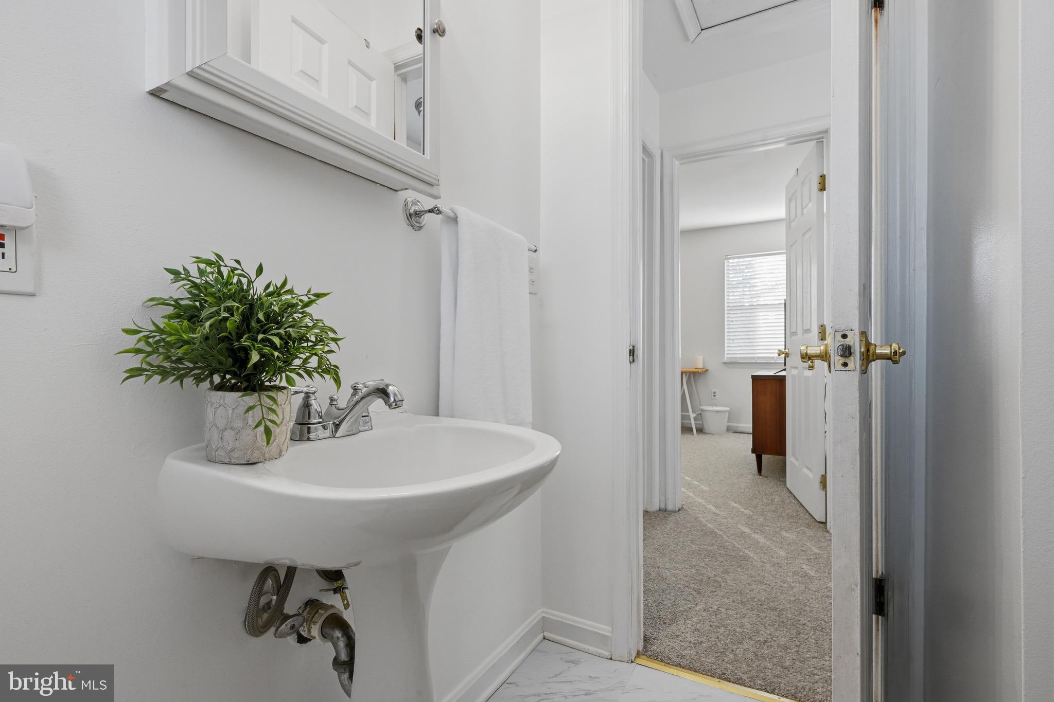 1707 Millstone Drive Edgewater, MD 21037 - Photo 15 of 39 a bathroom with a sink a mirror and shower
