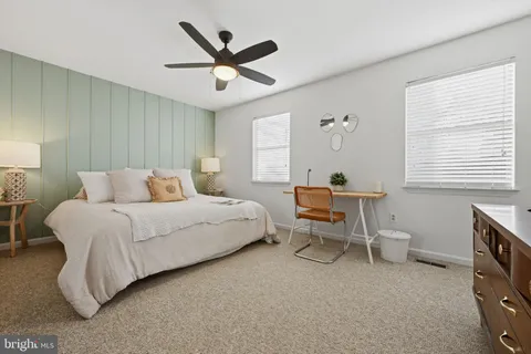 a bedroom with a bed a table and chair