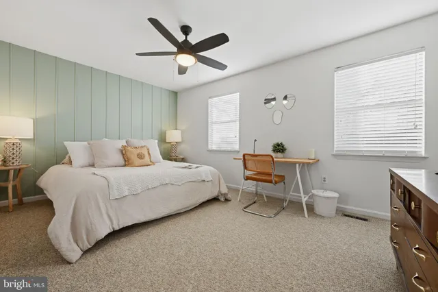 a bedroom with a bed a table and chair