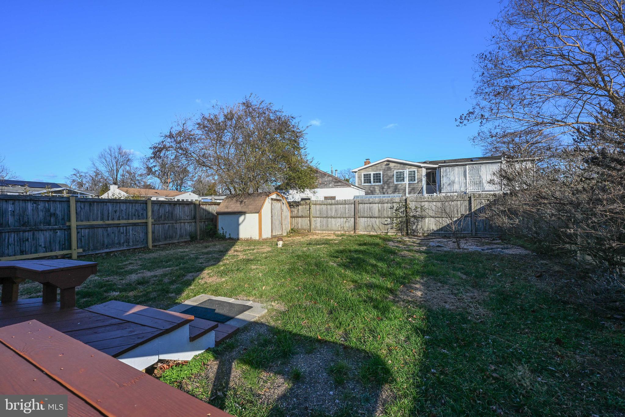 1707 Millstone Drive Edgewater, MD 21037 - Photo 25 of 39 a view of a backyard with plants and a bench