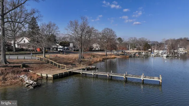 a view of a lake with boats and trees around