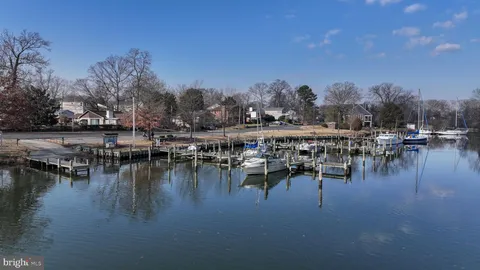 a view of a lake with boats and trees in the background